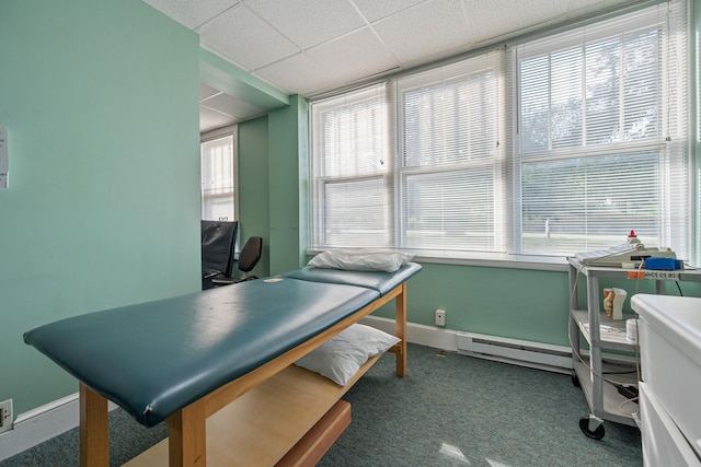 office space featuring a baseboard radiator, carpet, and a paneled ceiling