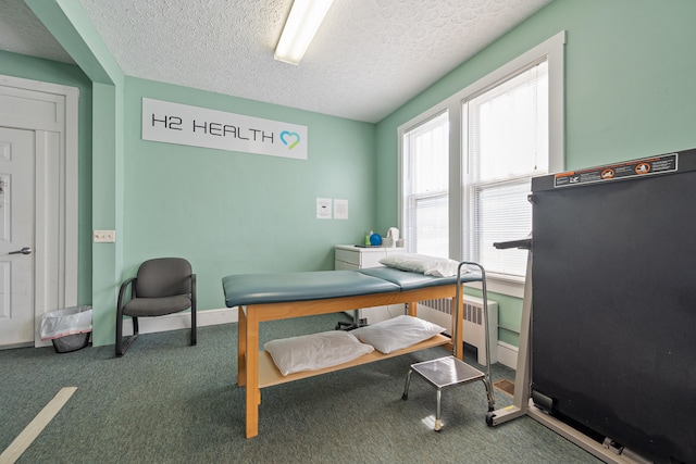 home office featuring carpet, radiator, and a textured ceiling