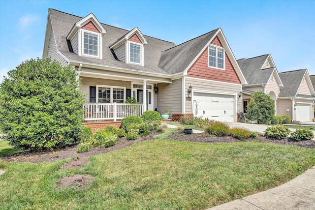 cape cod house featuring a garage, a porch, and a front lawn