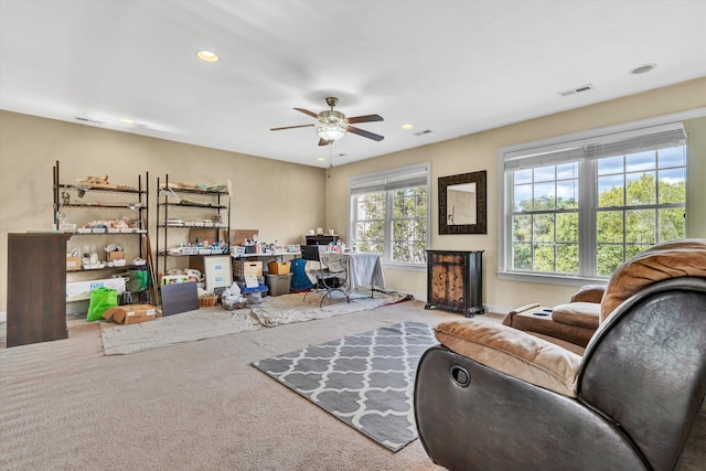 living room with ceiling fan and light colored carpet