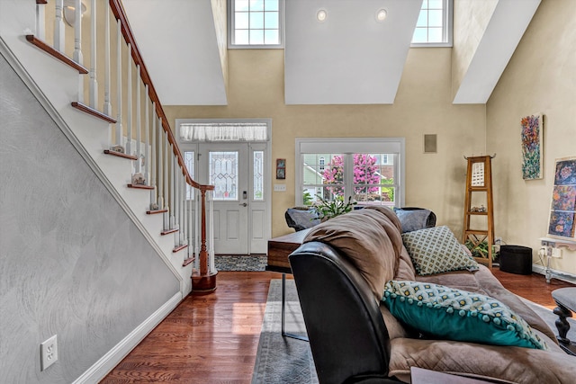 living room featuring plenty of natural light, hardwood / wood-style floors, and a high ceiling