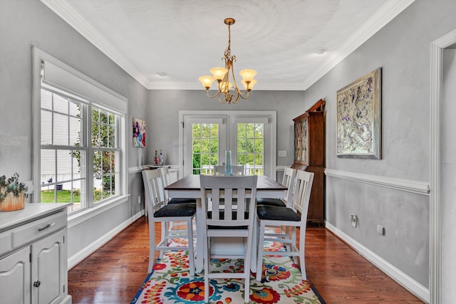 dining space with crown molding, dark hardwood / wood-style floors, and a notable chandelier