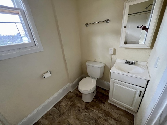 bathroom with vanity, toilet, and tile patterned floors