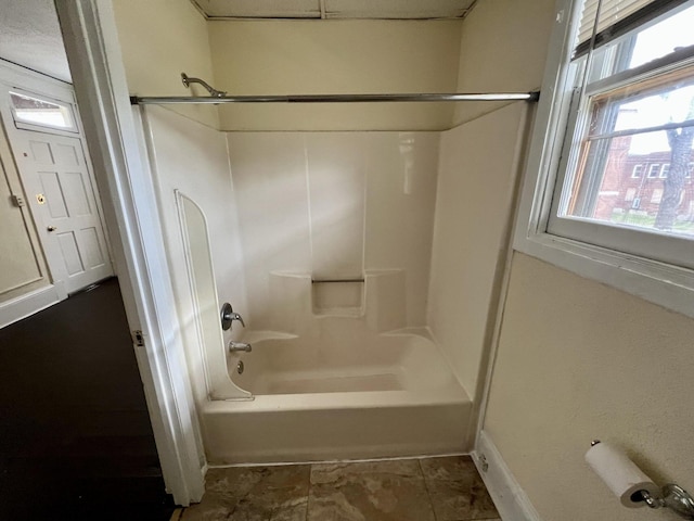 bathroom featuring tile patterned floors and  shower combination