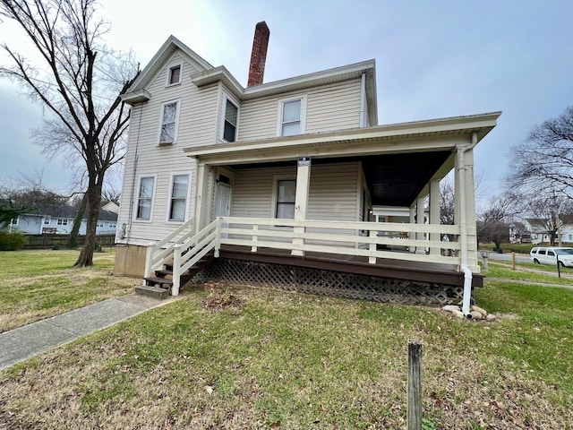 view of front of house with a porch and a front lawn