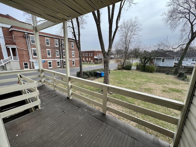 wooden terrace featuring a yard