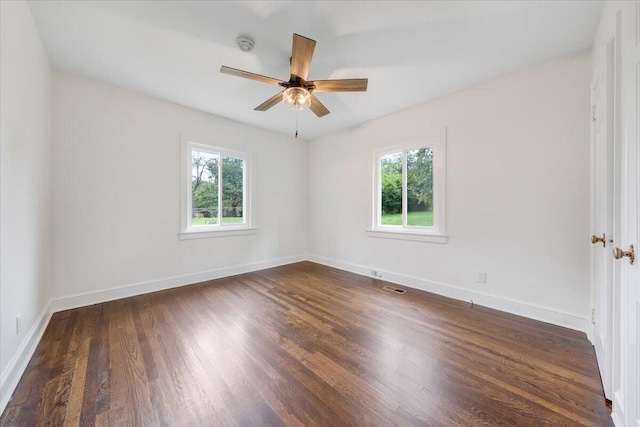 empty room featuring ceiling fan and dark hardwood / wood-style flooring