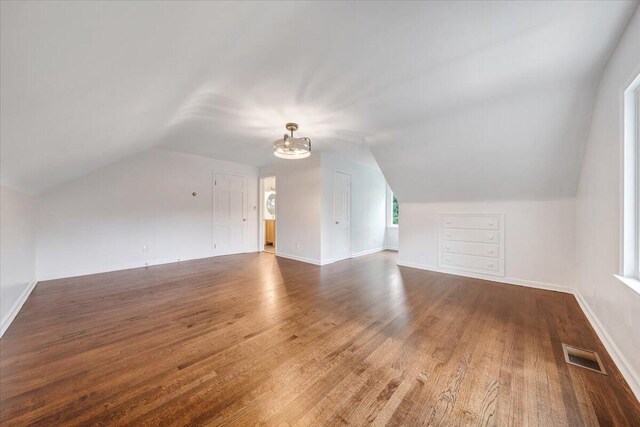 bonus room featuring lofted ceiling and wood-type flooring