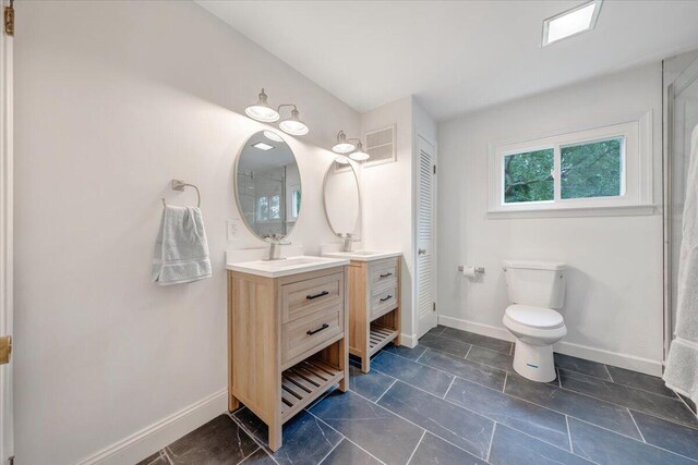 bathroom with tile patterned flooring, toilet, and vanity