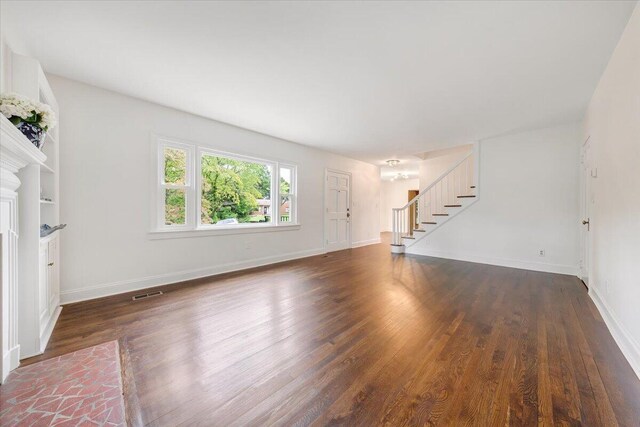 unfurnished living room featuring dark hardwood / wood-style floors