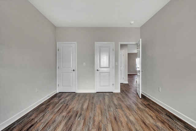 unfurnished bedroom featuring dark wood-type flooring