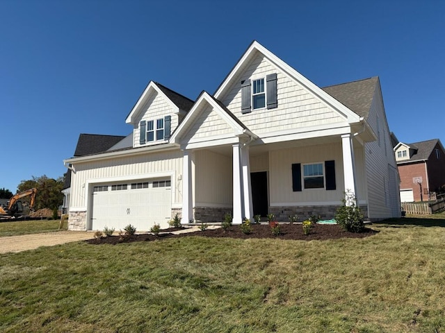 craftsman-style house featuring a garage and a front lawn