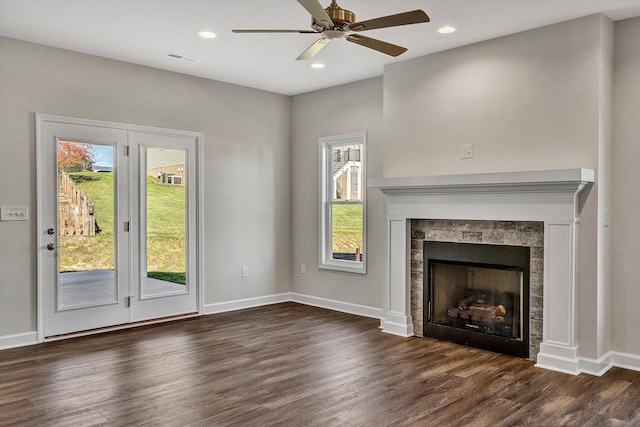 unfurnished living room featuring ceiling fan and dark hardwood / wood-style flooring