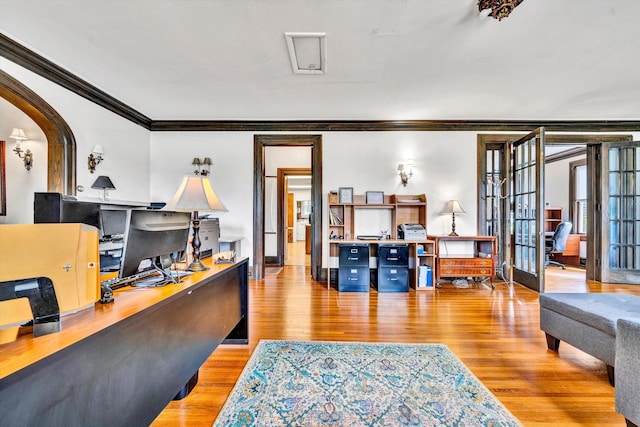 home office with light hardwood / wood-style flooring, french doors, and ornamental molding