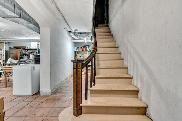 stairway with tile patterned flooring