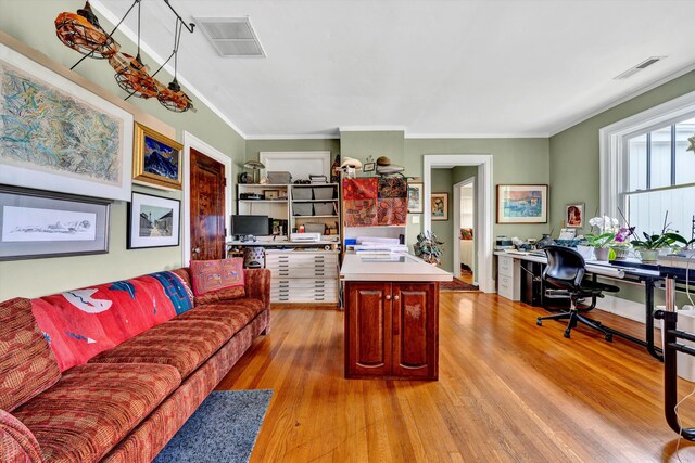 living room with light hardwood / wood-style flooring and ornamental molding