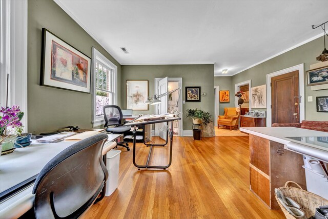 home office with light hardwood / wood-style flooring