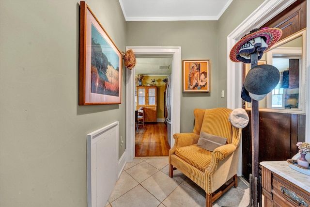 living area featuring light wood-type flooring, a wealth of natural light, and ornamental molding