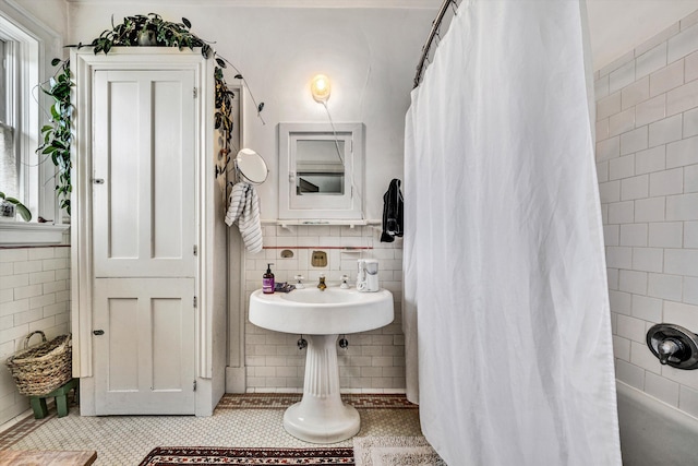 bathroom with tile patterned floors and tile walls