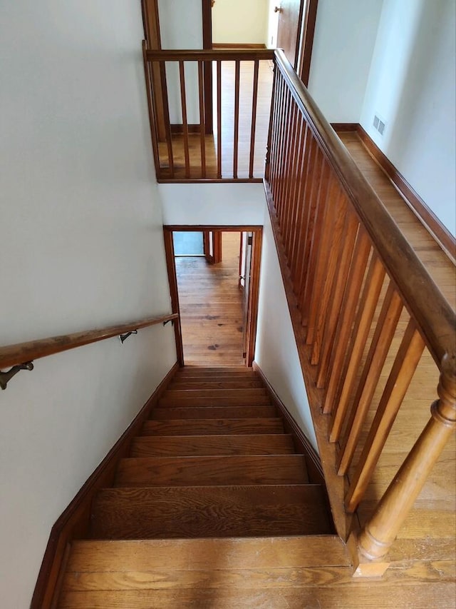 staircase featuring hardwood / wood-style flooring