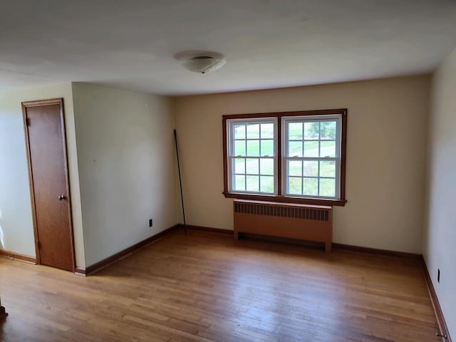 spare room with light hardwood / wood-style flooring and radiator