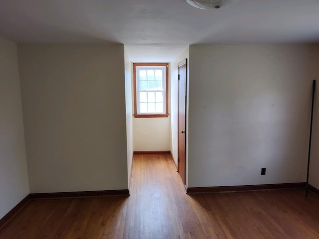 unfurnished room with hardwood / wood-style floors