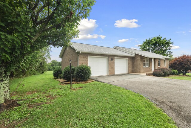 single story home with a garage and a front yard