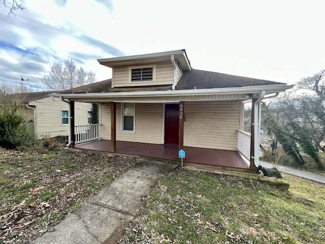 rear view of house featuring covered porch