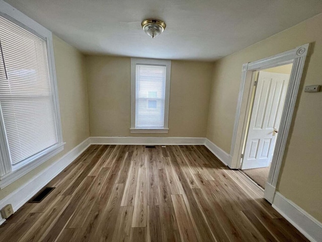 unfurnished room with wood-type flooring