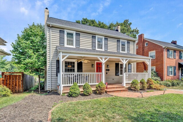 colonial inspired home with a front yard and a porch