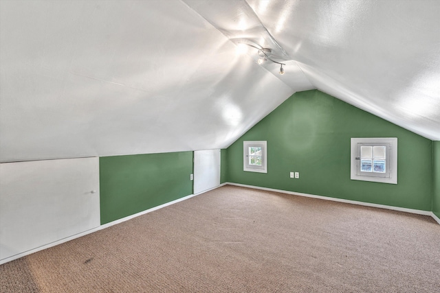 bonus room featuring vaulted ceiling and carpet flooring