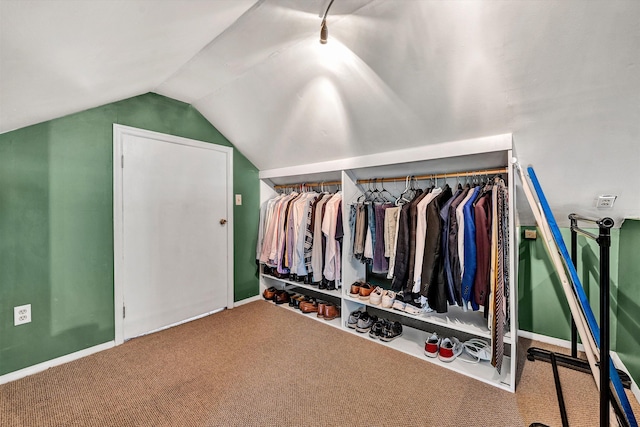 spacious closet with lofted ceiling and carpet