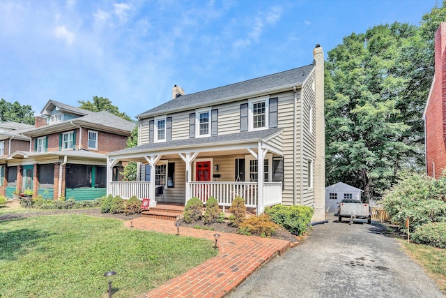 view of front of home with a porch and a front lawn