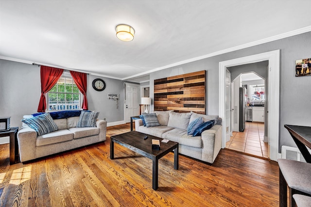 living room with crown molding and wood-type flooring