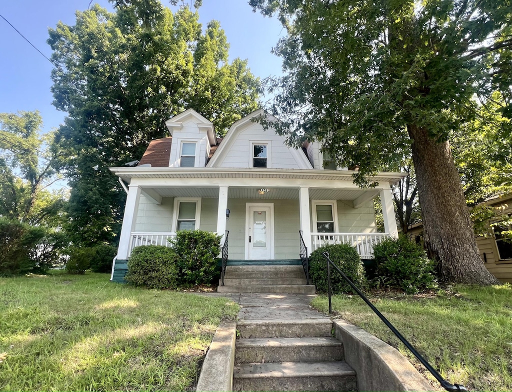 bungalow with a front lawn and a porch