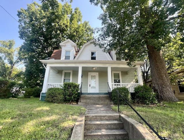 bungalow with a front lawn and a porch