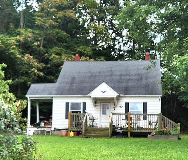 view of front facade featuring a front lawn and a wooden deck