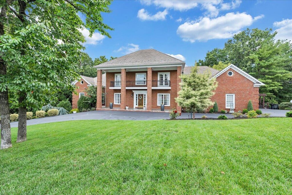 5325 Fox Ridge Rd, Roanoke, VA 24018 - exterior space featuring brick siding, a balcony, and a lawn