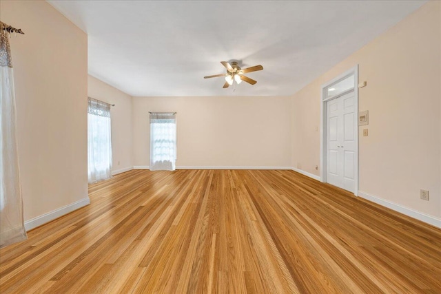 unfurnished room with ceiling fan and light hardwood / wood-style floors