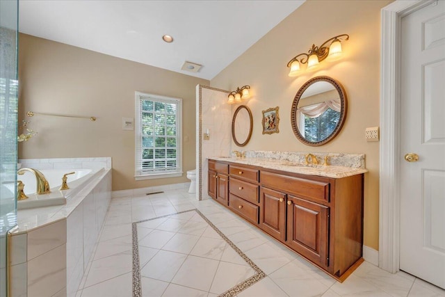 bathroom featuring lofted ceiling, tiled tub, tile patterned flooring, vanity, and toilet