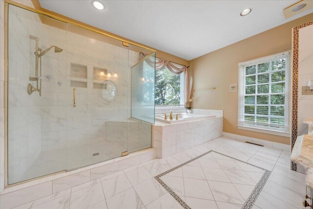 bathroom featuring shower with separate bathtub