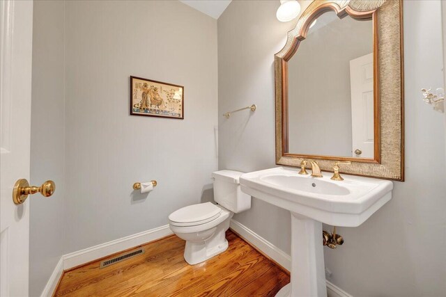 bathroom featuring hardwood / wood-style floors and toilet