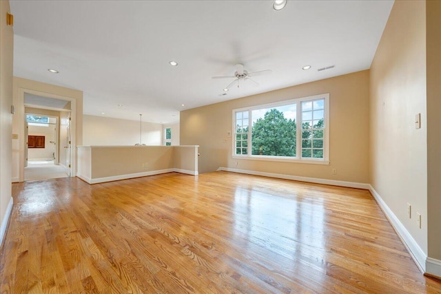 unfurnished room with ceiling fan and light wood-type flooring