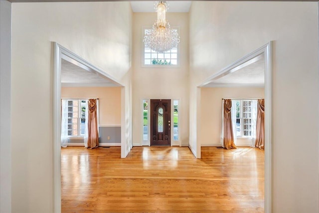 foyer entrance with a healthy amount of sunlight and light hardwood / wood-style floors