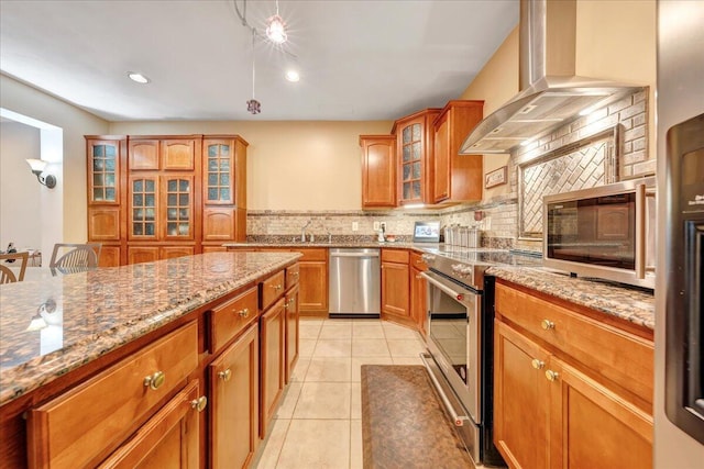 kitchen with decorative backsplash, light tile patterned floors, stainless steel appliances, light stone countertops, and wall chimney exhaust hood