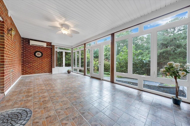 unfurnished sunroom with a wall mounted AC and ceiling fan