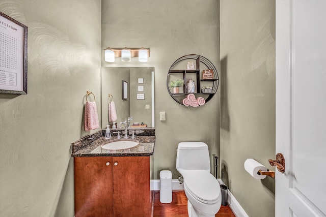 bathroom with toilet and vanity