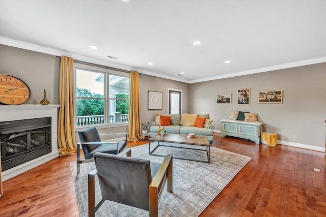 living room with ornamental molding and hardwood / wood-style flooring