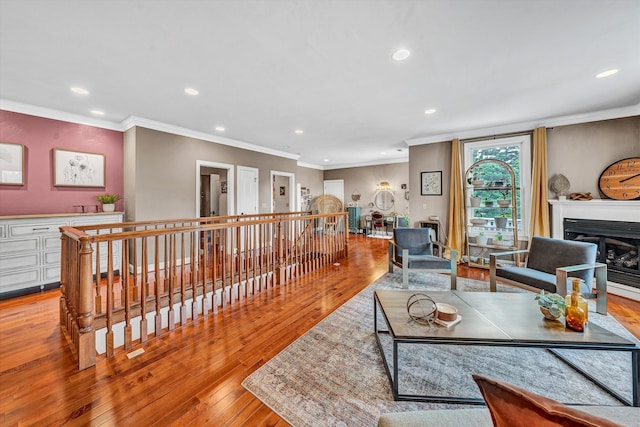 living room with light hardwood / wood-style flooring and crown molding