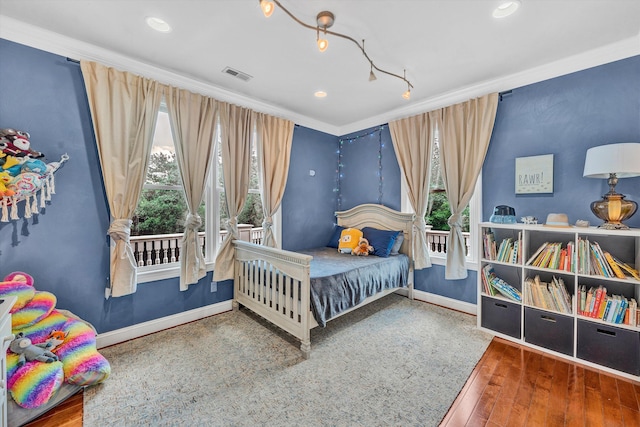 bedroom featuring wood-type flooring and ornamental molding